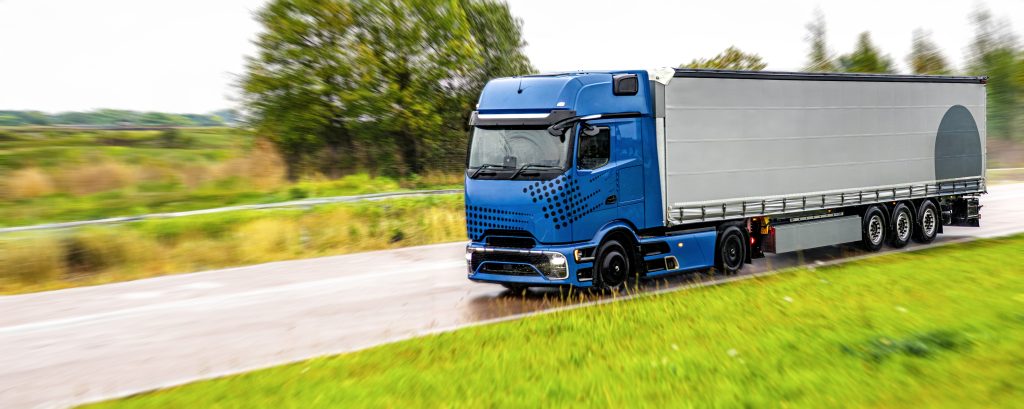 blue truck on wet road. power of modern logistics.